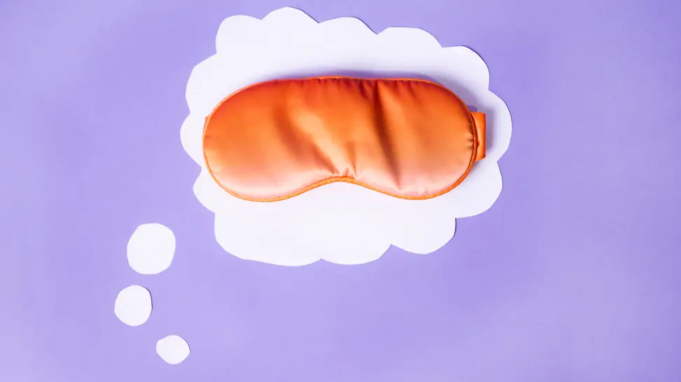 Orange satin sleep eye mask in white thought bubble.