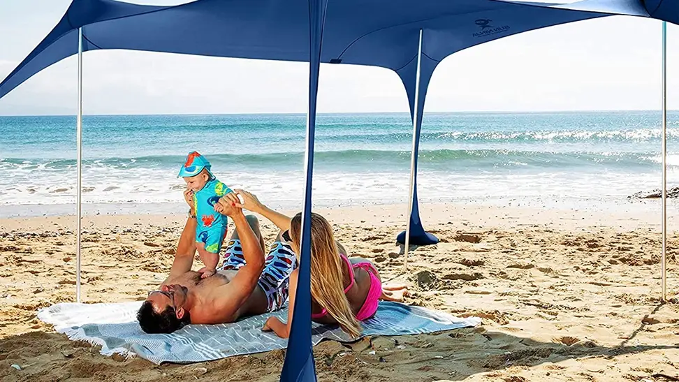 A family enjoying their beach tent on vacation.