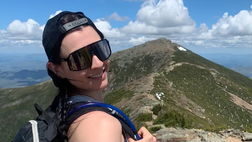 Staff Writer Lily Hartman wearing her Oakley sunglasses on the Franconia Ridge.