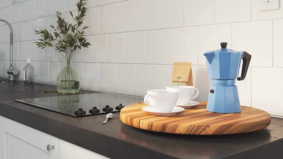 A lazy susan being used to hold tea and two mugs.