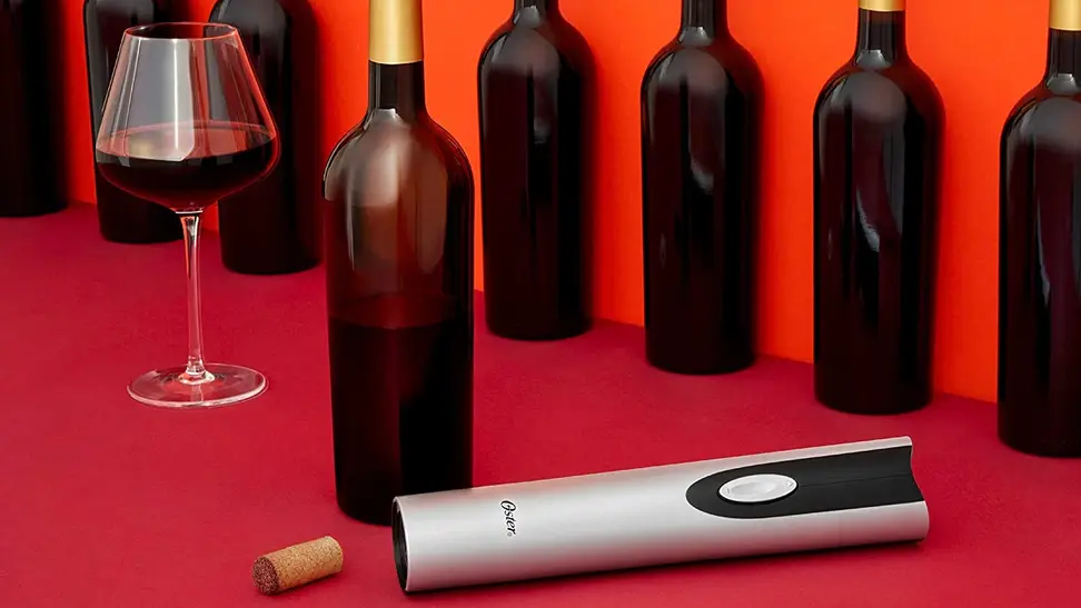 An electric wine bottle opener being used to open wine bottles.