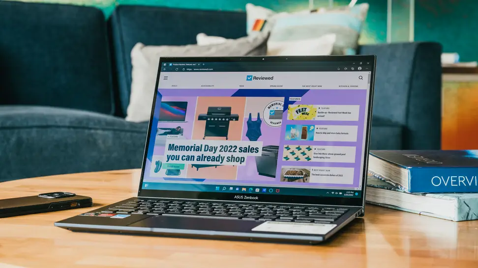 An open and powered on laptop displaying a colorful website