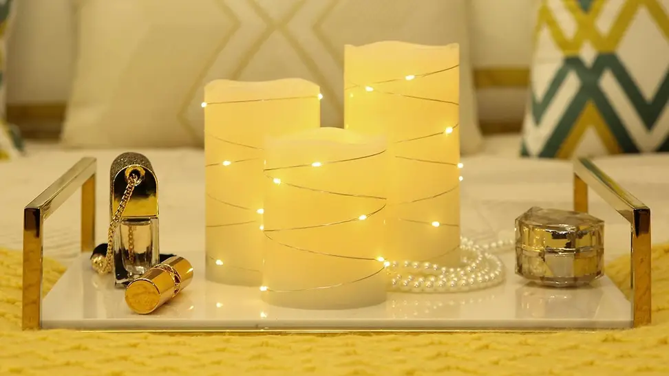 A set of candles with string lights in a living room.