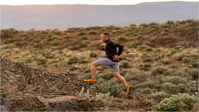 A trail runner moving on a trail on a ridge.