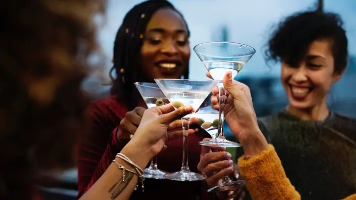 people cheers'ing with martinis