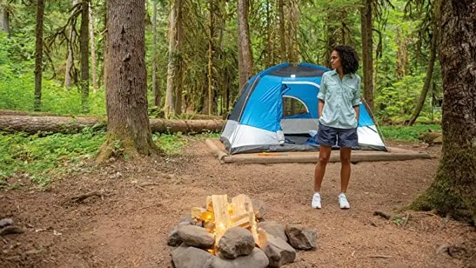 A woman wearing her go-to hiking shorts while camping.