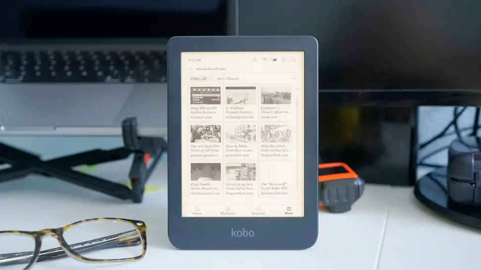 An e-reader propped up vertically on top of a desk.