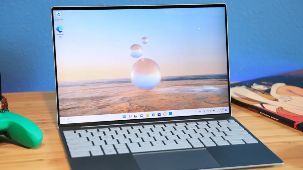 A Dell XPS 9315 sitting atop a desk while open.