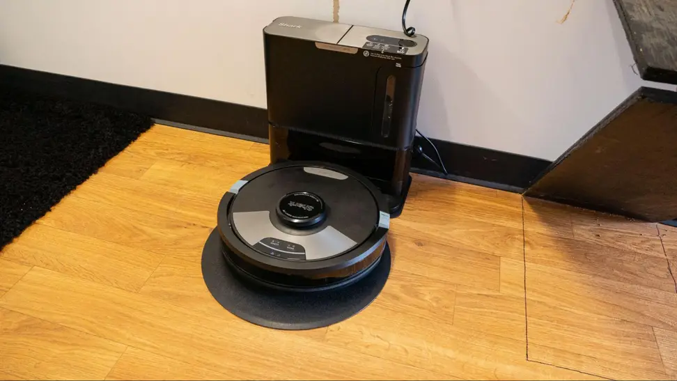 The Shark RV2610WA robot vacuum charging in its dock.