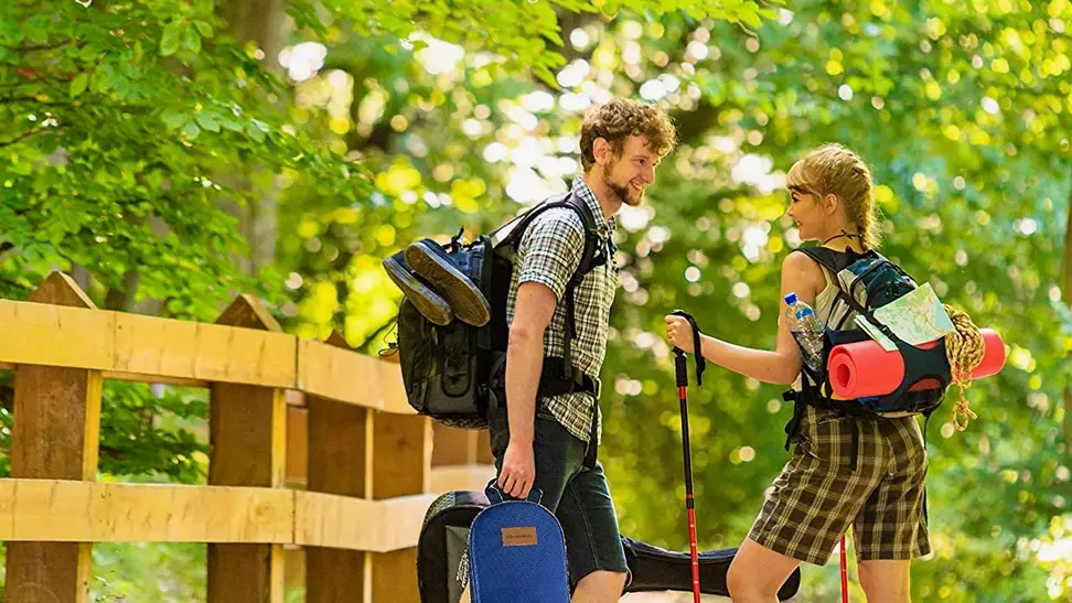 A pair of campers make their way through nature with the Wealers 11-piece camping utensil set in their pack.