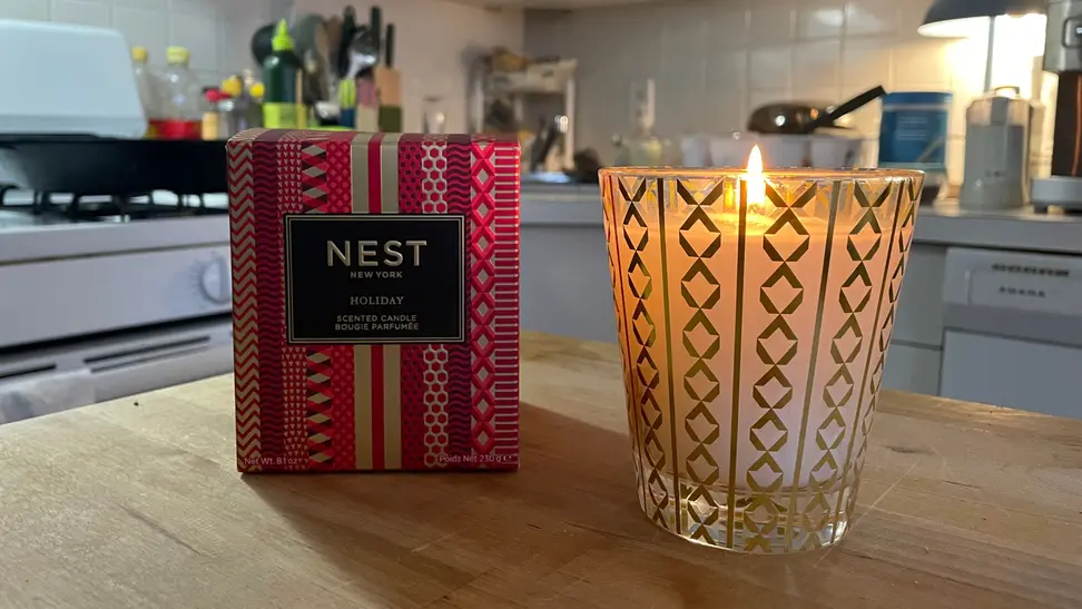 The Nest holiday candle on a kitchen counter.