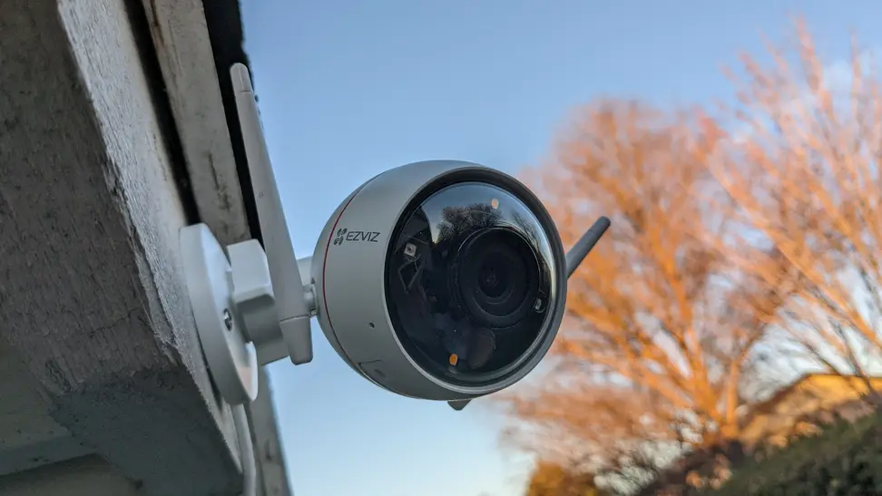 The The Ezviz C3W Pro hangs outside overlooking a yard