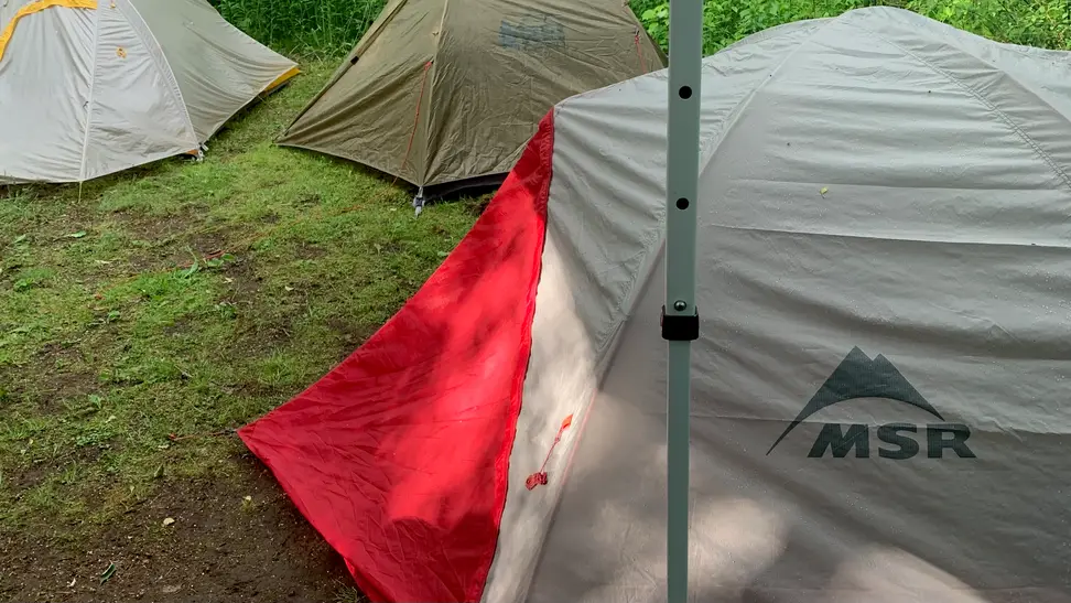 Backpacking tents being used by friends at a campsite.