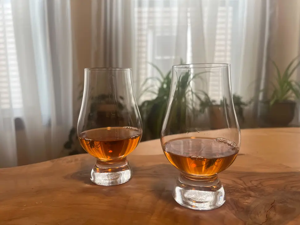 Two glasses of whiskey in Glencairn whiskey glasses.