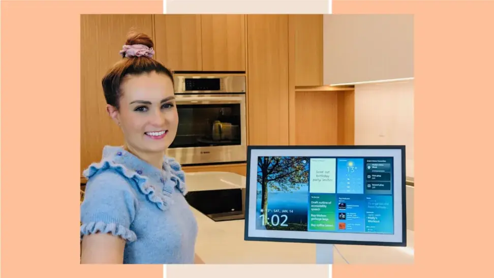 Molly Burke posing next to an Echo Show 15.