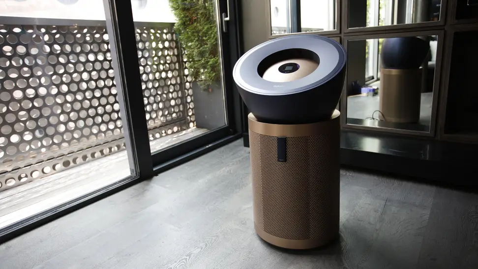 Dyson Big+Quiet Formaldehyde Air Purifier indoors in front of large sliding glass door.