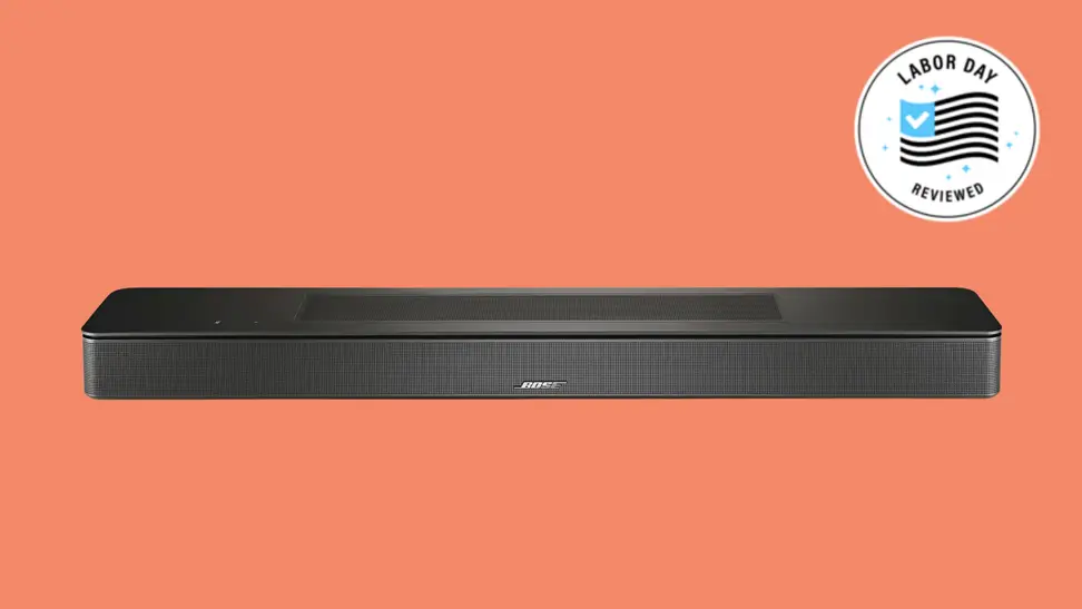 A Bose soundbar sits on a reddish background.