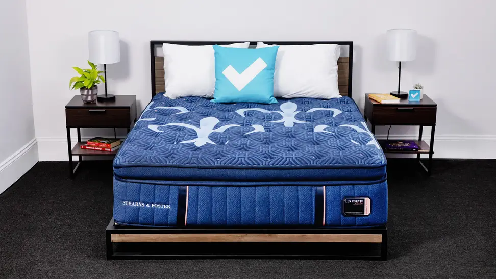 The Stearns & Foster  Lux Estate Pillow Top mattress in a bedroom between two bedside tables.