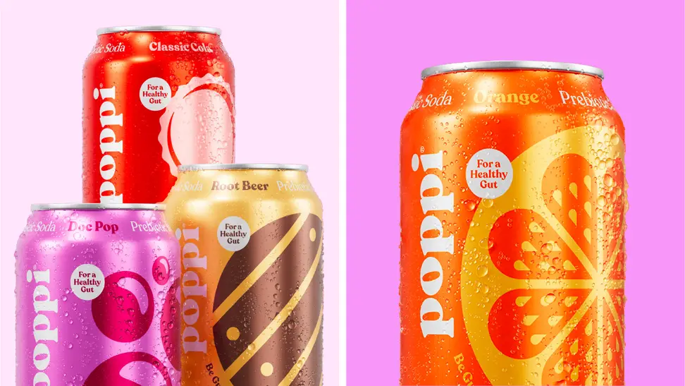 An image of several cans of Poppi soda, including a can of Doc Pop, Clasisic Cola, Root Beer, and Orange soda.