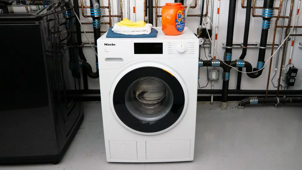 The Miele WWD660WCS Washing Machine in the Reviewed Labs with a box of Tide pods on top.