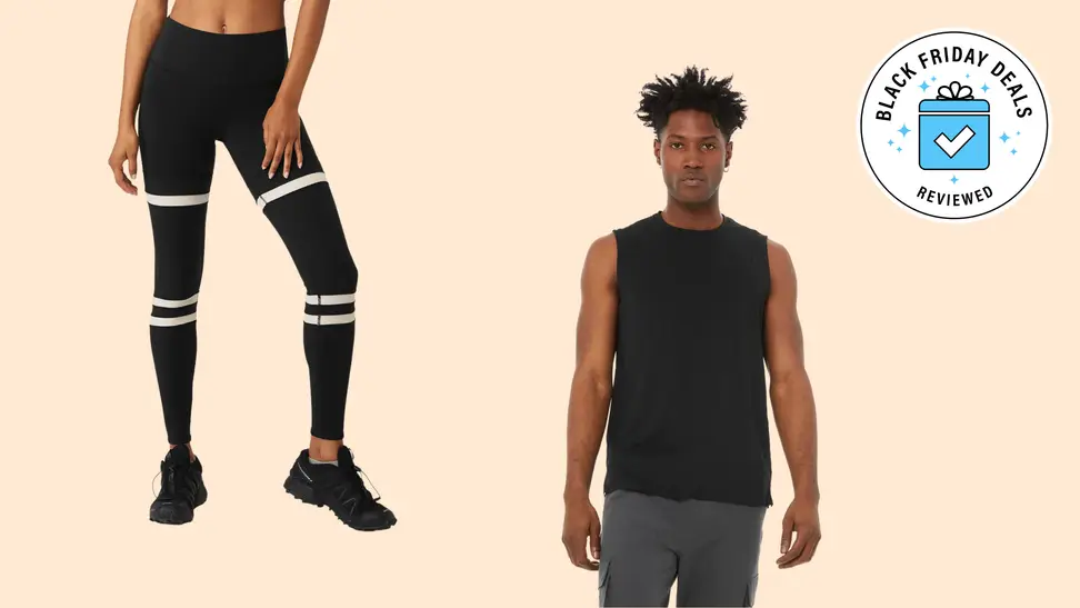 A pair of leggings and tank top on a beige background.