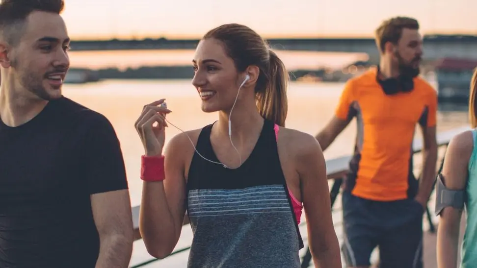 group of people exercising on a bridge