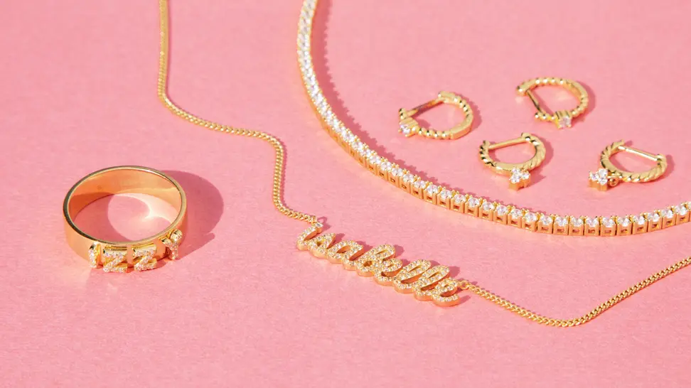 gold jewelry on pink background