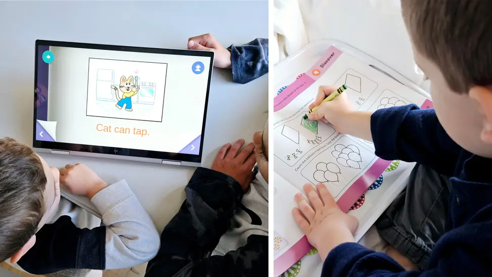 A group of children interacting with a tablet and coloring.