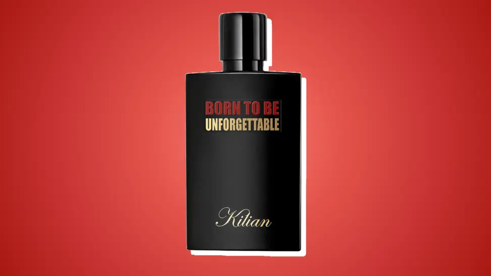 Kilian Paris Born to be Unforgettable perfume against a dark red background.
