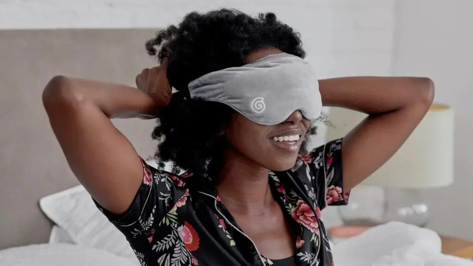 Person with weighted eye mask over eyes.