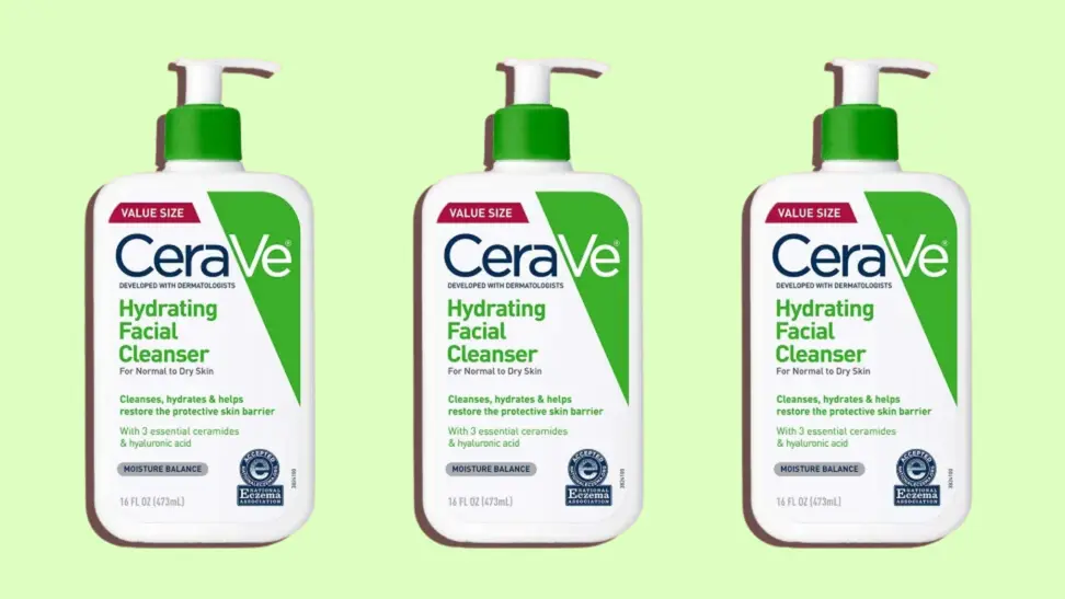 Three bottles of CeraVe Hydrating Facial Cleanser on a green background.