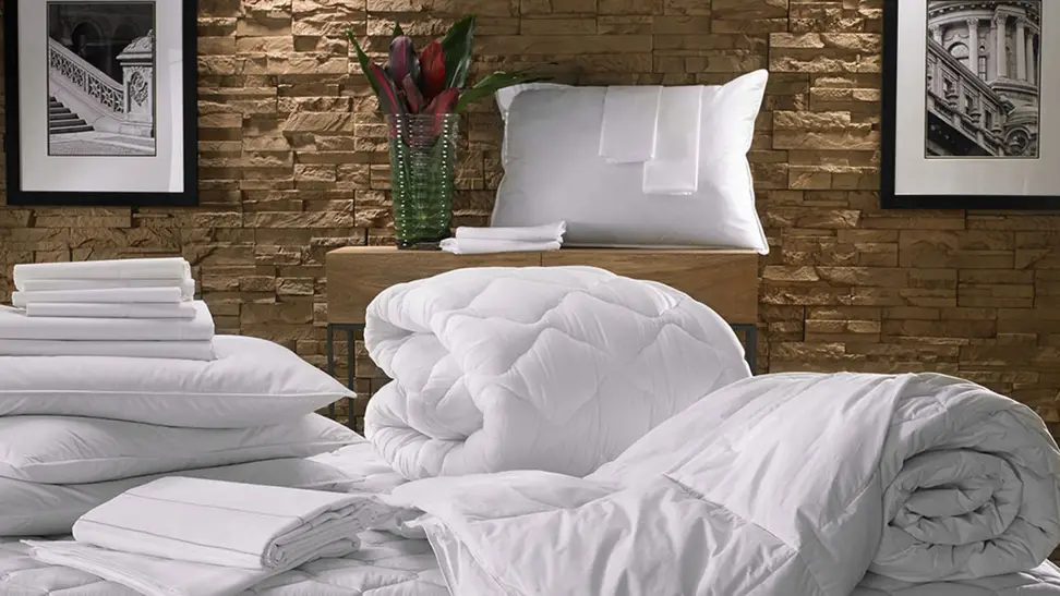 A platinum stitch Marriott bedding set in a bedroom background.