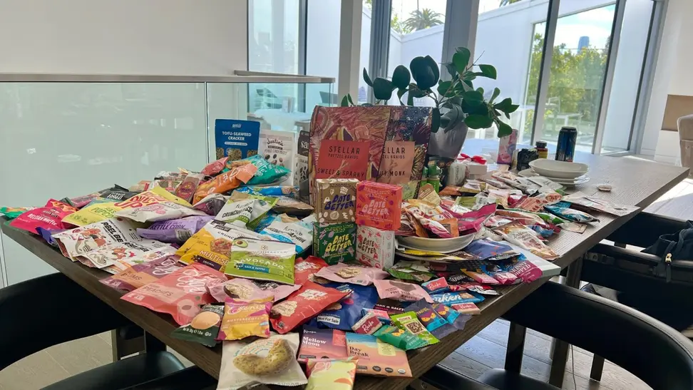 A table filled with a large variety of snack packages