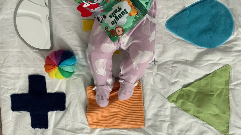Baby legs on a KiwiCo playmat