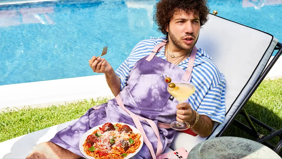 Benny Blanco in purple tie-dye apron