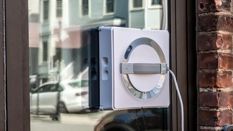The Ecovacs Winbot W2 Omni window cleaning robot cleaning a window outdoors.
