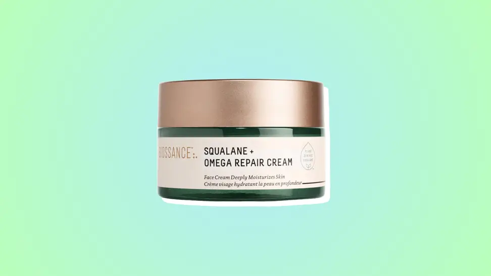 Photo of the Biossance Squalane + Omega Repair Cream against a blue and green background