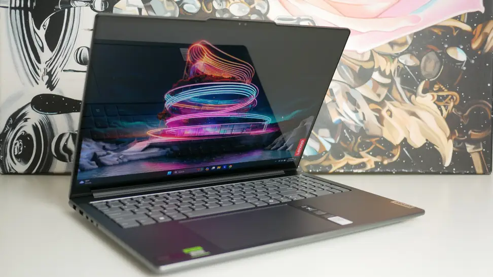 The Lenovo Yoga Pro 9i 16 Gen 9 half closed sitting atop a table.
