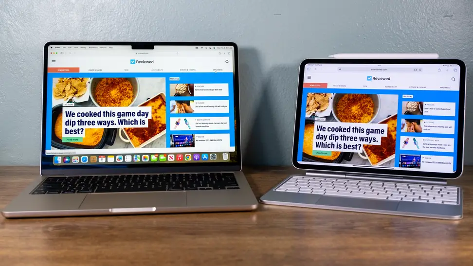 An Apple MacBook Air and iPad Pro show off bright screens as they sit on a table surface
