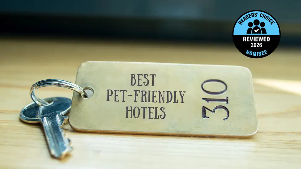 A brass hotel key with a room number on a table