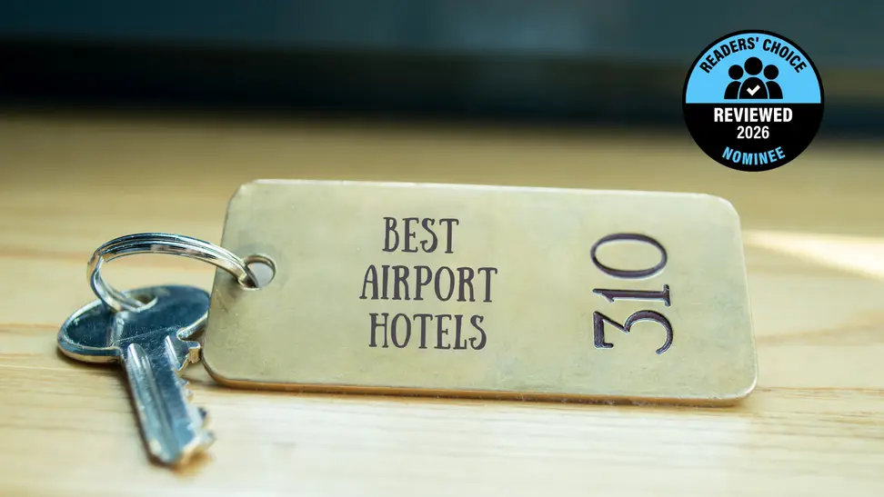 A brass hotel key with a room number on a table